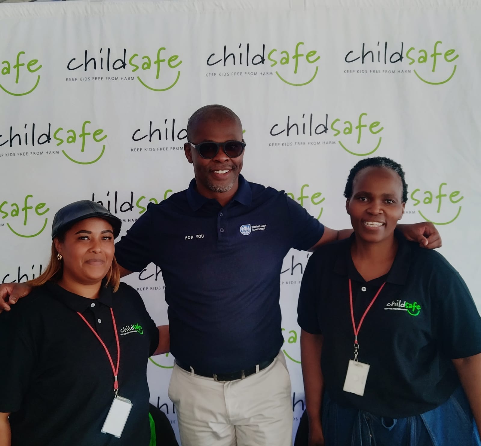 Gadijah Barron, the Honourable Western Cape Minister of Mobility Isaac Sileku, and Sindisiwe Zungu at the ChildSafe SA stall during the Mobility Open Day.