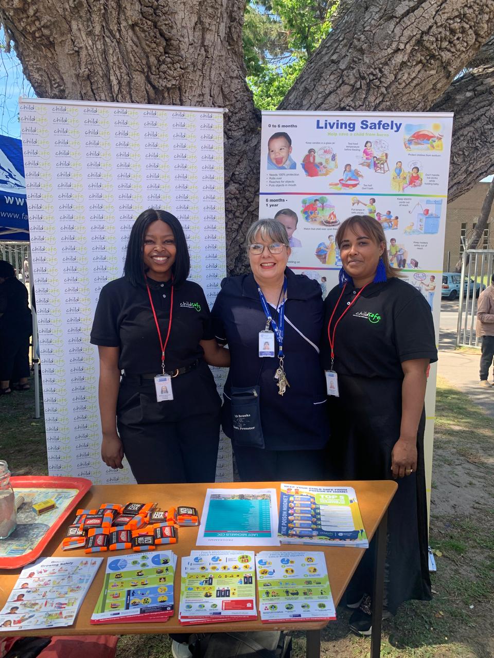 ChildSafe South Africa representatives Sindisiwe Zungu and Gadijah Barron with Lady Michaelis CDC Health Promoter Sister Leigh Brooks at the clinic open day display table.